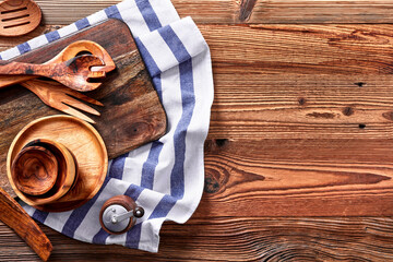 Kitchen utensils and towel on a wooden table