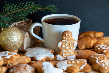 Happy New Year's set of gingerbread from ginger biscuits glazed sugar icing decoration on black background, minimal seasonal pandemic winter holiday banner