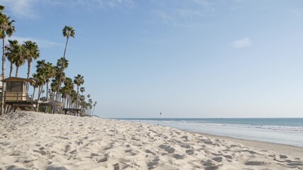 Tropical palm trees, white sandy beach by sea water wave, pacific ocean coast, San Clemente...