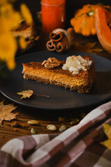 Homemade pumpkin cheesecake decorated with whipped cream.