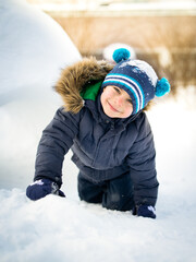 Portrait of preschool smiling boy in winter outdoors 