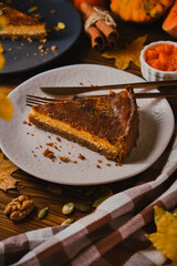 Homemade pumpkin cheesecake decorated with whipped cream.