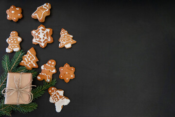Happy New Year's set of gingerbread from ginger biscuits glazed sugar icing decoration on black...
