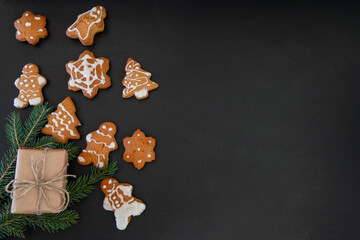 Happy New Year's set of gingerbread from ginger biscuits glazed sugar icing decoration on black background, minimal seasonal pandemic winter holiday banner