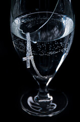 a Christian cross in a bowl of water