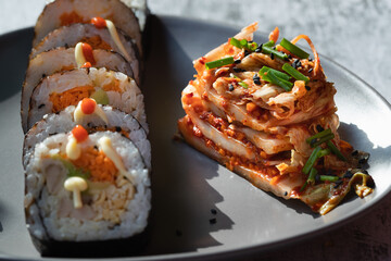 Korean traditional food Kimbap rolls slices, served with Kimchi