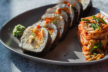 Korean traditional food Kimbap rolls slices, served with Kimchi