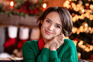 Photo of cute millennial brunette lady hands head wear green sweater at home on holiday