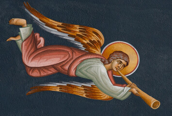 a painting on the wall representing an angel sounding the trumpet at the Cormaia monastery -...