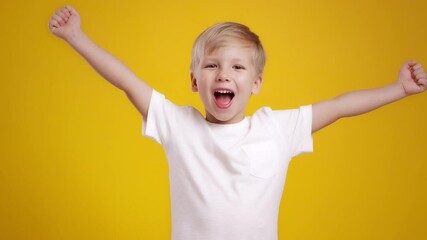 Sincere kids joy. Emotional little blonde boy celebrating success, shouting hooray and outstretching hands - Powered by Adobe