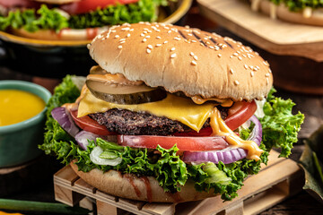 Closeup of home made burgers on wooden background. assorted take out or delivery foods