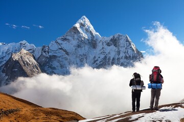 Mount Ama Dablam with two tourists, Himalayas mountains