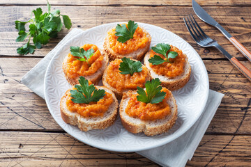 Sandwiches with bread zucchini caviar tomatoes onions. Homemade vegetarian food. Canned stewed vegetable. wooden background