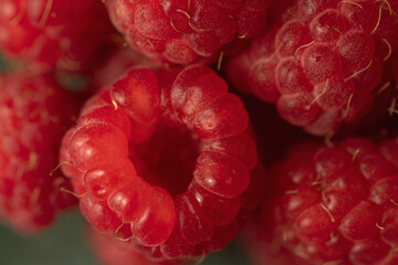 Ripe red raspberries on a plate.