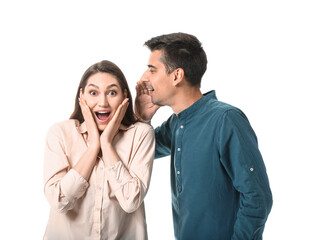 Young man sharing gossip with his girlfriend on white background