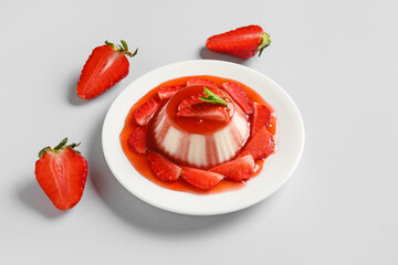 Delicious homemade strawberry panna cotta with mint on light background