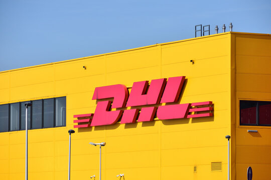 DHL signage, logo on the facade of DHL Express Service Point at Cargo Terminal of Warsaw Chopin Airport. WARSAW, POLAND - SEPTEMBER 11, 2021
