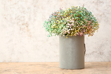 Box with beautiful gypsophila flowers on table