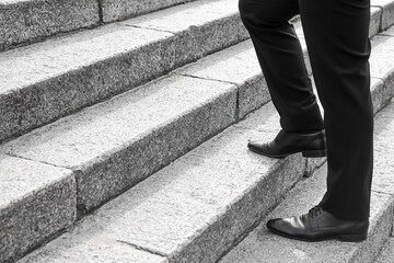 Businessman walking up the stairs outdoors