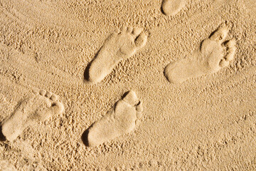 Foot prints in the sand. The concept of travel and vacation by the sea. Foot disease, orthopedic problems, flat feet, heel, toenails diseases