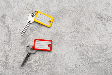 Keys with colorful plastic tags on grunge background