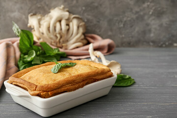 Baking dish with tasty mushroom pot pie on table