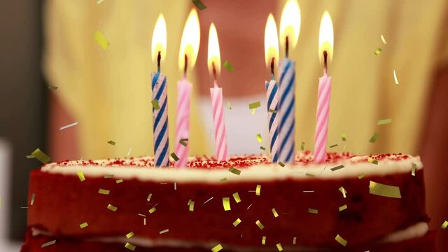 Animation Of Gold Confetti Falling Over Lit Candles On Birthday Cake