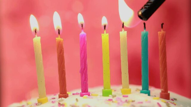 Animation of burning layer over lit candles on birthday cake