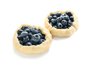 Raw blueberry galettes on white background