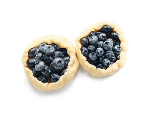 Raw blueberry galettes on white background