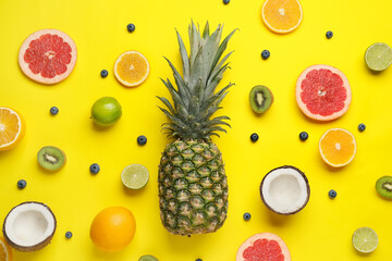 Composition with different fruits and berries on color background