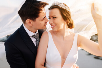 Just married couple under the bride veil