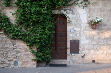 Fototapeta na wymiar Wooden Old Door of Assisi, Italy