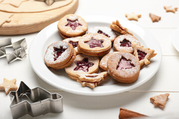 Plate with tasty Linzer cookies on white table