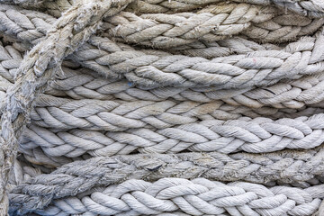 Fototapeta na wymiar Textured surface of gray mooring rope made from natural fibers