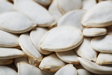 Pumpkin seeds in a shell close-up, macro as a background.