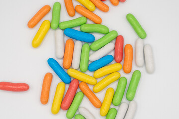 handful of colorful sweet candies on light background