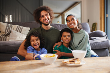 Family eating breakfast in living room
