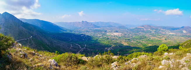 Fototapeta na wymiar Great panorama of the mountainous valley with small white villages in the distance. Alicante Spain.