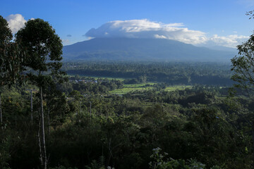 The view of the clouds above the mountain with the blue sky background creates a comfortable and cool atmosphere