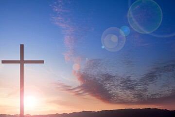 Religious Christian cross with sunset sky