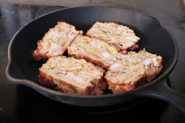 Frying scrapple slices on a cast iron pan