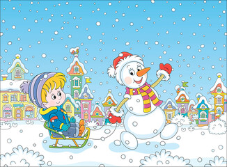 Funny snowman friendly smiling, waving its hand in greeting and sledding a happy little boy down a snow-covered street of a pretty small town on a beautiful winter day, vector cartoon