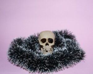 human skull wrapped in a Christmas decoration