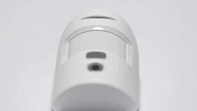 Security alarm sensor on the wall of the house, wireless motion detector sends an alarm signal. High quality 4k footage