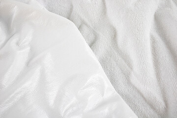 White texture close-up of material for making waterproof mattress covers. Protection of the bed from water and baby secretions. Production of mattress covers from cotton materials