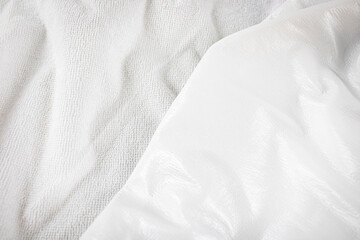 White texture close-up of material for making waterproof mattress covers. Protection of the bed from water and baby secretions. Production of mattress covers from cotton materials - obrazy, fototapety, plakaty