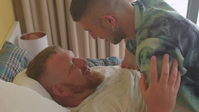 Lovers kissing in bed. Healthy relationships involve honesty, trust and open communication in family regardless of your sexual orientation. Respects his chosen gender pronouns, name and boundaries. 