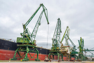 Fototapeta na wymiar Mobile Harbor Green Cranes for Bulk Handling