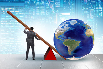 Businessman lifting the earth in challenge concept